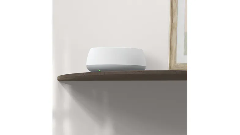 A white, TP-Link mesh unit sitting on a wooden shelf. A white, TP-Link mesh unit sitting on a wooden shelf.
