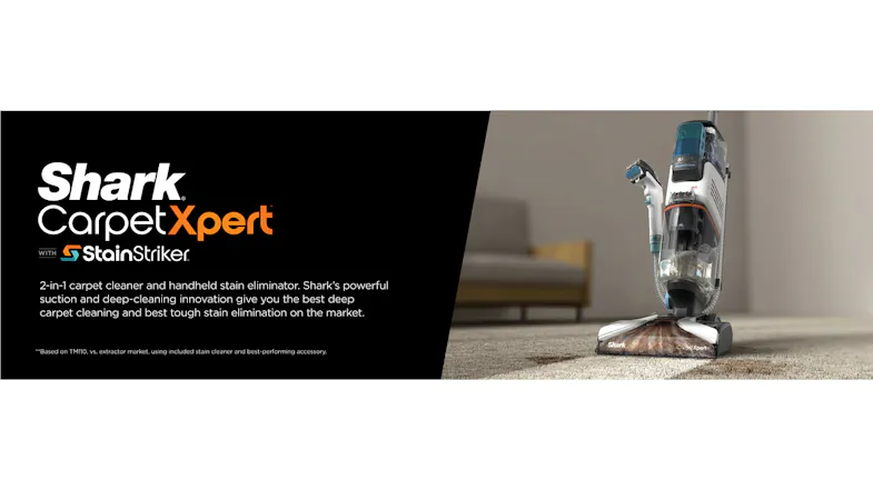 A Shark CarpetXpert upright carpet cleaner stands on a carpet, actively cleaning a dark stain A Shark CarpetXpert upright carpet cleaner stands on a carpet, actively cleaning a dark stain