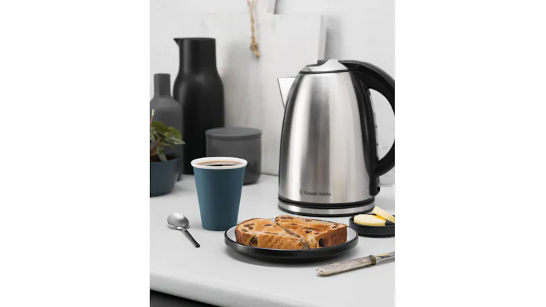 Close-up of a Russell Hobbs Montana kettle on a kitchen counter next to coffee and toast Close-up of a Russell Hobbs Montana kettle on a kitchen counter next to coffee and toast