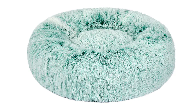 A round, fluffy teal pet bed with raised sides and a soft, plush texture A round, fluffy teal pet bed with raised sides and a soft, plush texture