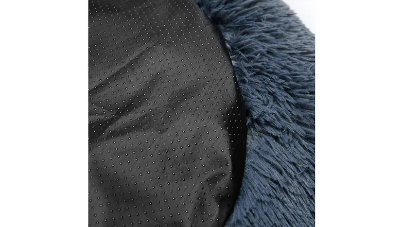 Close-up of a black non-slip fabric base next to a blue fluffy faux fur from a pet bed Close-up of a black non-slip fabric base next to a blue fluffy faux fur from a pet bed