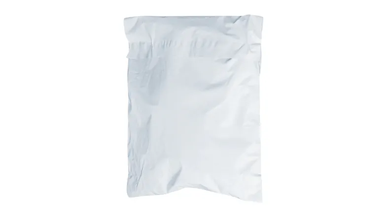 Compressed pet bed packed securely in a simple white shipping bag Compressed pet bed packed securely in a simple white shipping bag