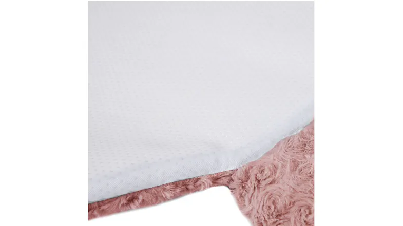 Detail view of the white non-slip underside and fluffy pink fabric of the pet cushion Detail view of the white non-slip underside and fluffy pink fabric of the pet cushion