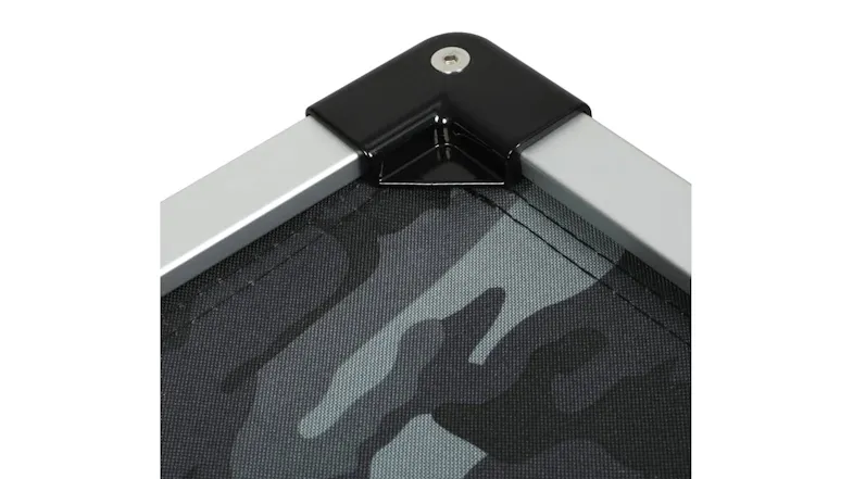 Corner view of an elevated dog bed showing a black connector and a camo mesh fabric Corner view of an elevated dog bed showing a black connector and a camo mesh fabric