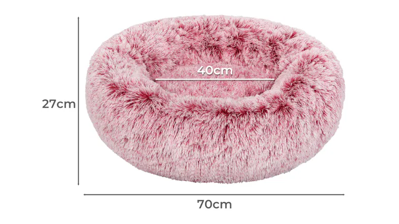 A fluffy pink-coloured pet bed showing its labelled dimensions A fluffy pink-coloured pet bed showing its labelled dimensions