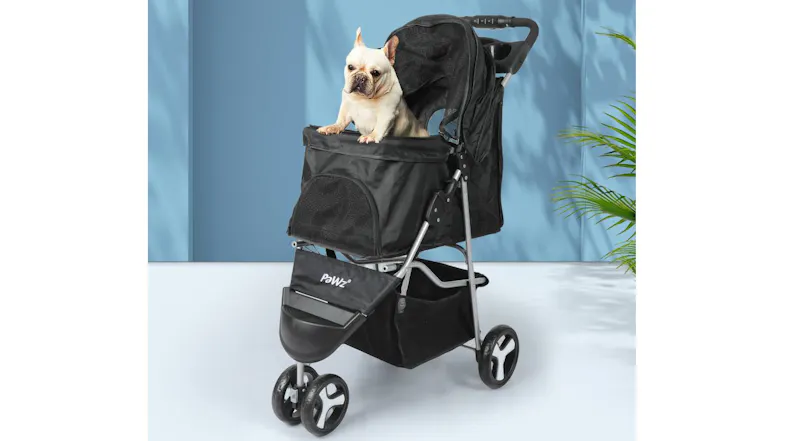 Small dog resting inside PaWz tri‑wheel pet stroller indoors, showing spacious cabin and breathable mesh panels Small dog resting inside PaWz tri‑wheel pet stroller indoors, showing spacious cabin and breathable mesh panels
