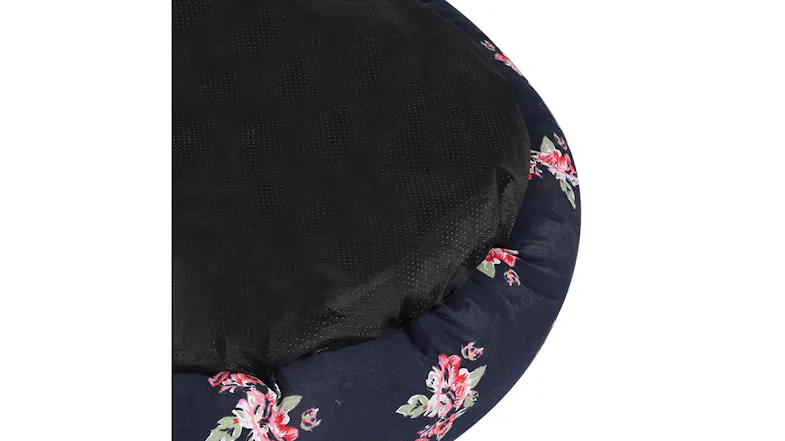 Close-up of a floral pet bed with a black non-slip bottom panel Close-up of a floral pet bed with a black non-slip bottom panel