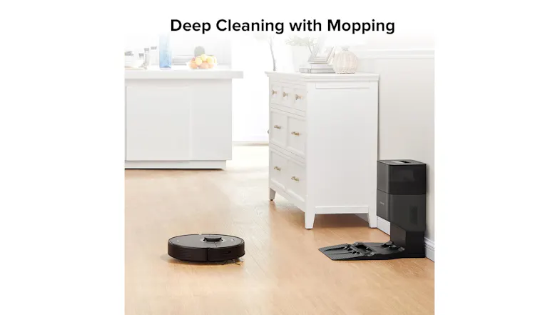 A robot vacuum is cleaning a bright kitchen floor, with its dock visible in the background, showcasing its deep-cleaning mop function A robot vacuum is cleaning a bright kitchen floor, with its dock visible in the background, showcasing its deep-cleaning mop function