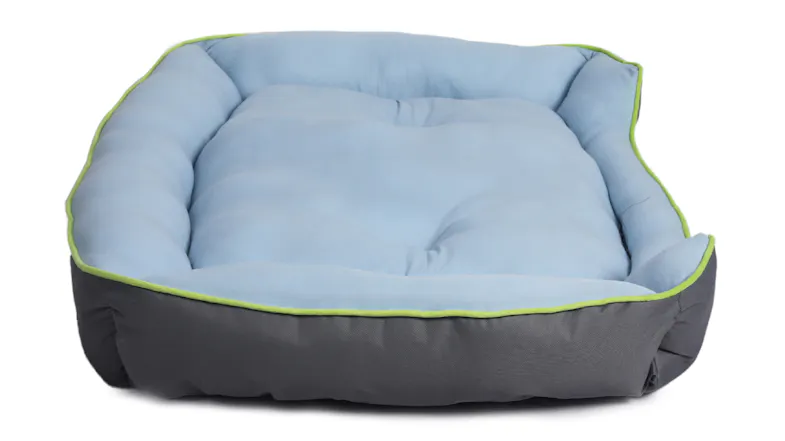 A side view of the light blue and grey cooling pet bed featuring a soft padded centre and raised sides A side view of the light blue and grey cooling pet bed featuring a soft padded centre and raised sides