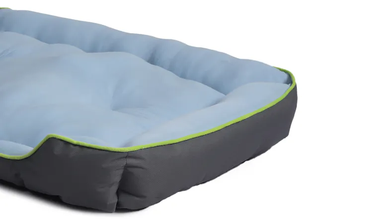 Angled view of the cooling pet bed showing its light blue padded surface and grey sides, withthe cooling pet bed shown with its labelled dimensions Angled view of the cooling pet bed showing its light blue padded surface and grey sides, withthe cooling pet bed shown with its labelled dimensions