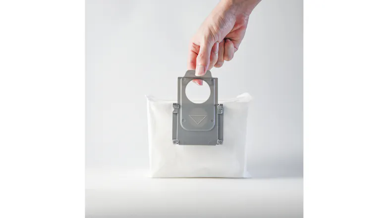 Hand lifting a white Roborock Q8 Max+ disposable dust bag by its grey plastic handle Hand lifting a white Roborock Q8 Max+ disposable dust bag by its grey plastic handle