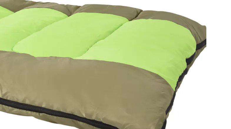 Close-up of a sleeping bag corner showing green padding, brown fabric, and zipper detail Close-up of a sleeping bag corner showing green padding, brown fabric, and zipper detail