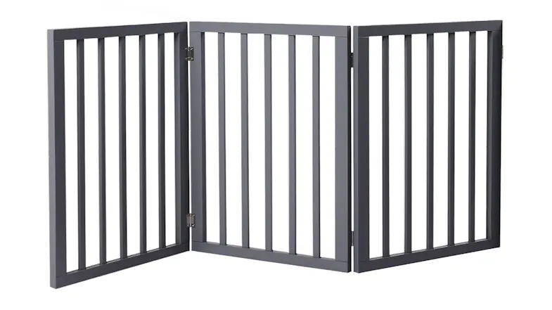 Grey three-panel wooden pet gate with vertical slats and folding hinges shown standing upright Grey three-panel wooden pet gate with vertical slats and folding hinges shown standing upright