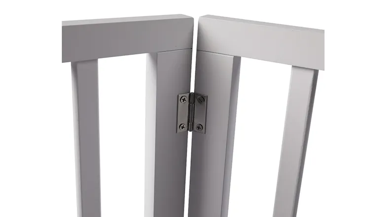 Close‑up view of a metal hinge connecting white wooden pet gate panels, showing sturdy hardware for smooth folding movement Close‑up view of a metal hinge connecting white wooden pet gate panels, showing sturdy hardware for smooth folding movement