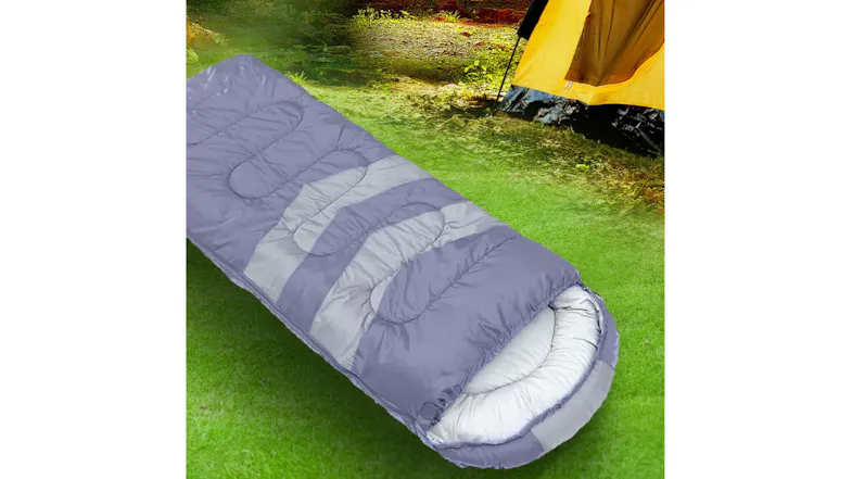 A purple and grey sleeping bag lay on the grass near a yellow tent, showing a padded hood A purple and grey sleeping bag lay on the grass near a yellow tent, showing a padded hood