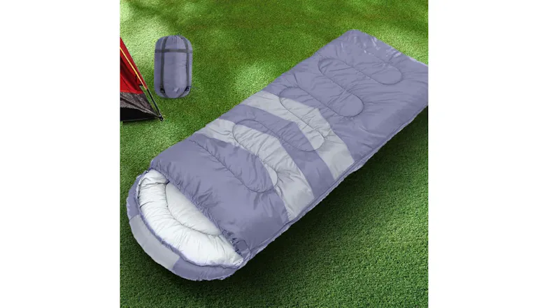 Purple and grey Mountview sleeping bag lay on the grass near a yellow tent, showing a padded hood Purple and grey Mountview sleeping bag lay on the grass near a yellow tent, showing a padded hood