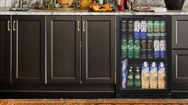 A home bar or kitchen setting with a smaller Husky beverage fridge installed under the counter A home bar or kitchen setting with a smaller Husky beverage fridge installed under the counter