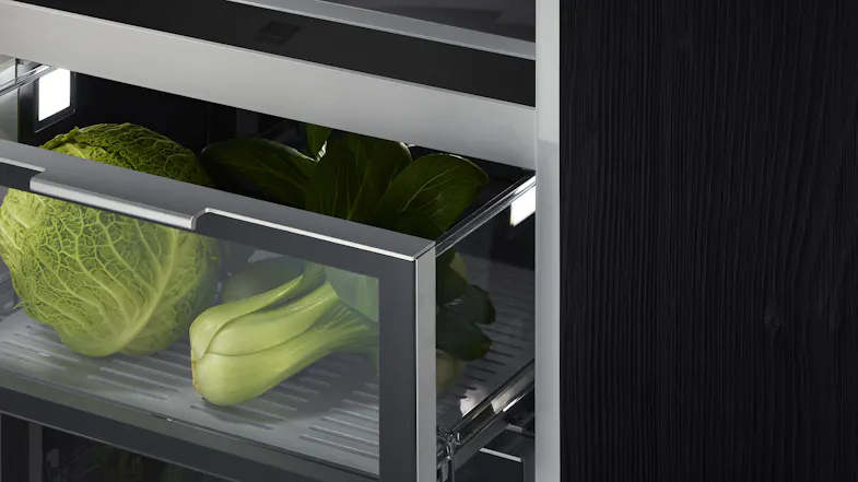 A close of view of one of the bins with some vegetables inside A close of view of one of the bins with some vegetables inside