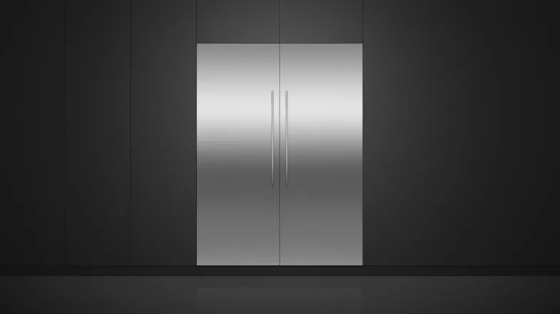 A view of the fridge and its compatible freezer installed flush on a sleek black wall A view of the fridge and its compatible freezer installed flush on a sleek black wall