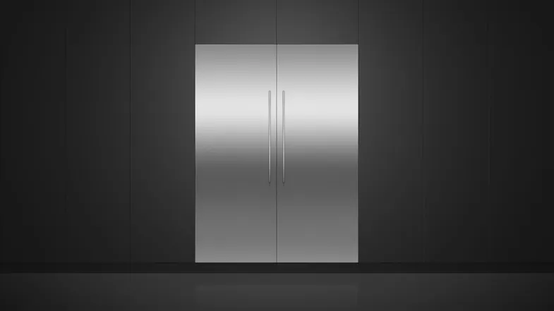A view of the fridge and its compatible freezer installed flush on a sleek black wall A view of the fridge and its compatible freezer installed flush on a sleek black wall