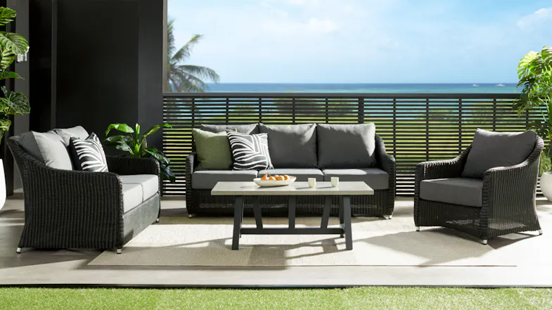 A wide outdoor setting showing the Toulouse three‑seater sofa, two armchairs, and a coffee table overlooking the ocean. A wide outdoor setting showing the Toulouse three‑seater sofa, two armchairs, and a coffee table overlooking the ocean.