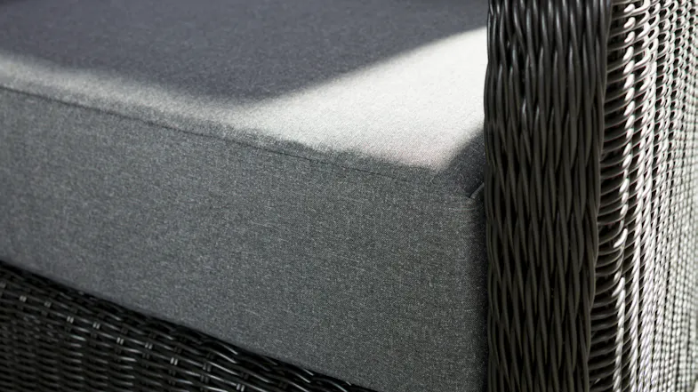 Close‑up view of the Toulouse outdoor sofa’s armrest and seat cushion, showing the dark woven wicker texture. Close‑up view of the Toulouse outdoor sofa’s armrest and seat cushion, showing the dark woven wicker texture.