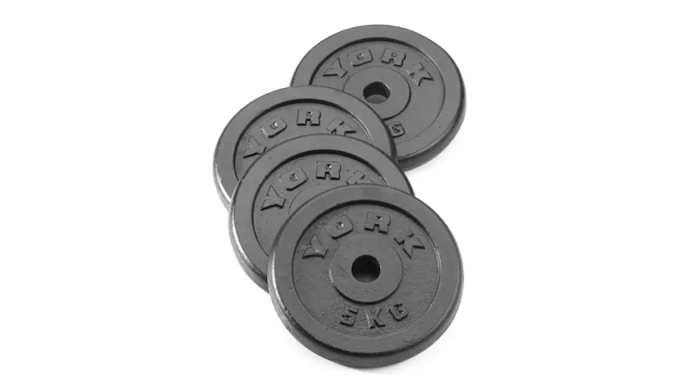 A small overlapping stack of four black cast iron York weight plates A small overlapping stack of four black cast iron York weight plates