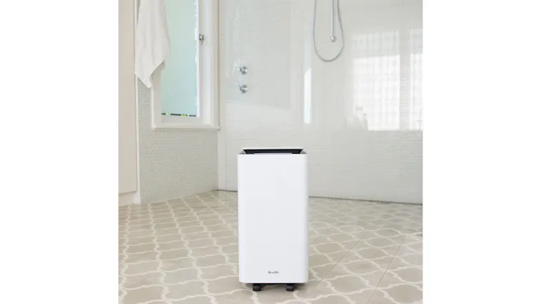 A white dehumidifier is placed on a tiled bathroom floor, demonstrating its suitability for high-moisture environments A white dehumidifier is placed on a tiled bathroom floor, demonstrating its suitability for high-moisture environments