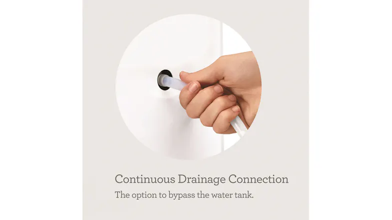 A hand attaches a hose to the rear port for continuous drainage, allowing the unit to bypass the water tank A hand attaches a hose to the rear port for continuous drainage, allowing the unit to bypass the water tank