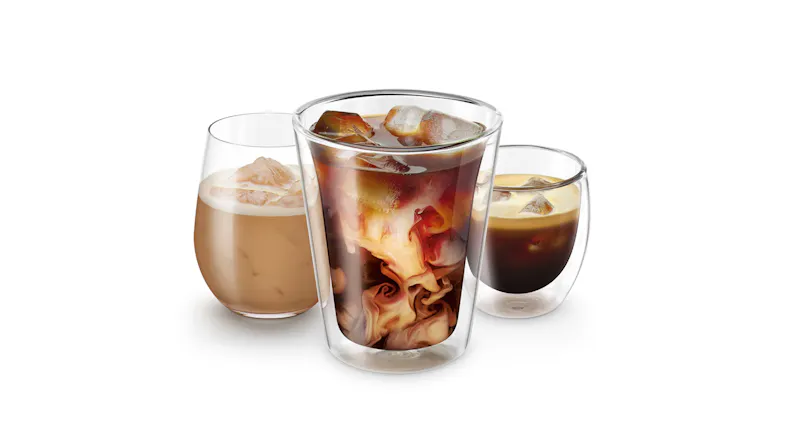 A trio of iced coffee drinks in double-walled glasses. A trio of iced coffee drinks in double-walled glasses.