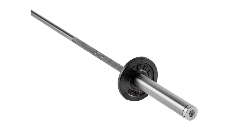 A silver chrome barbell sleeve with a single small black York weight plate loaded onto it A silver chrome barbell sleeve with a single small black York weight plate loaded onto it