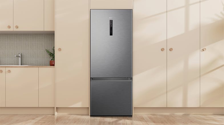 Haier 500 Series 334L Bottom Mount Fridge in a modern kitchen with light wood cabinetry Haier 500 Series 334L Bottom Mount Fridge in a modern kitchen with light wood cabinetry