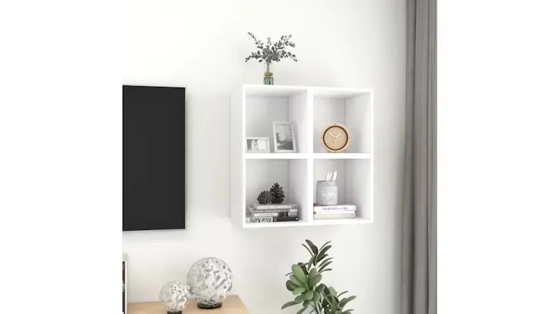 Four floating square shelves displaying home decor next to a TV and indoor plants Four floating square shelves displaying home decor next to a TV and indoor plants