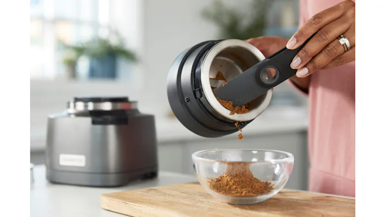 Emptying the Kenwood grinder bowl with the black folding spatula accessory Emptying the Kenwood grinder bowl with the black folding spatula accessory