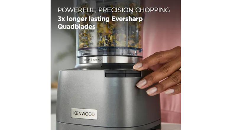 Hand pressing the button on the Kenwood Duo Prep to chop ingredients Hand pressing the button on the Kenwood Duo Prep to chop ingredients