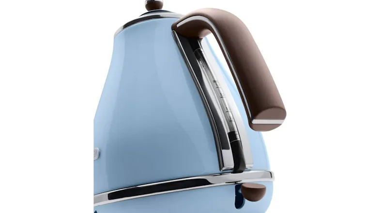 A close-up of a vintage Azure kettle showing its brown handle, chrome accents, and water level indicator on the side A close-up of a vintage Azure kettle showing its brown handle, chrome accents, and water level indicator on the side
