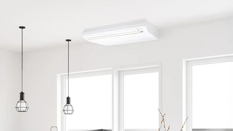 A heat pump air conditioner in a modern room with pendant lights and large windows A heat pump air conditioner in a modern room with pendant lights and large windows