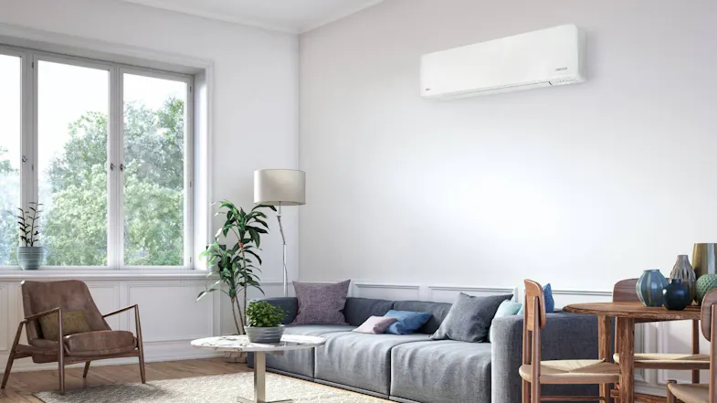A Fujitsu heat pump air conditioner in a sunlit living room A Fujitsu heat pump air conditioner in a sunlit living room