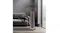 The Goldair graphite tower heater placed in a modern grey living room next to a sofa The Goldair graphite tower heater placed in a modern grey living room next to a sofa