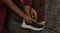 A person with a smart ring is tying a shoelace outdoors A person with a smart ring is tying a shoelace outdoors