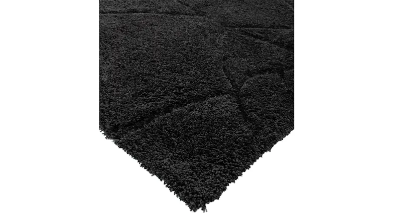 Corner view showing thick pile and intersecting lines on an charcoal background Corner view showing thick pile and intersecting lines on an charcoal background