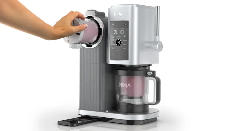 A hand attaches the swirl lid onto the Ninja Swirl by CREAMi machine while the main container sits in the base, ready for use A hand attaches the swirl lid onto the Ninja Swirl by CREAMi machine while the main container sits in the base, ready for use