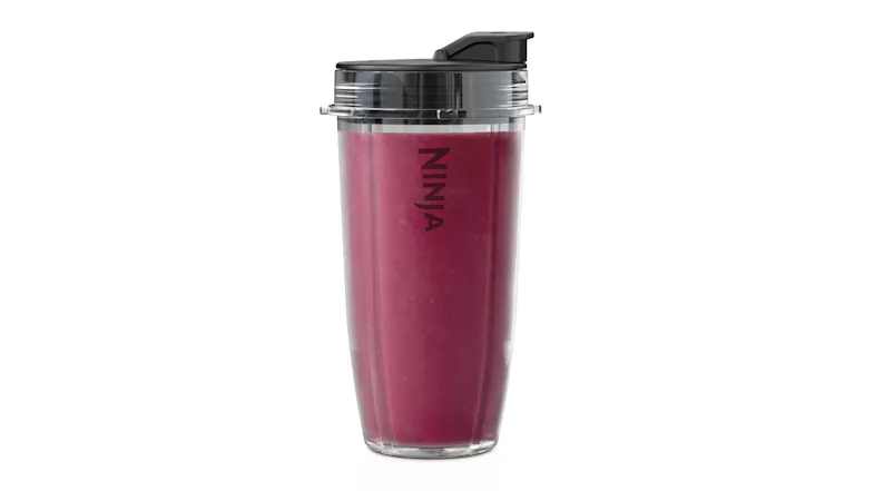 Ninja single-serve blender cup filled with a purple smoothie, with the lid attached Ninja single-serve blender cup filled with a purple smoothie, with the lid attached