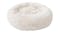A round, fluffy, white coloured pet bed with a soft raised rim A round, fluffy, white coloured pet bed with a soft raised rim