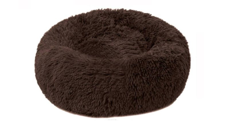 A round, fluffy, brown pet bed designed for small animals like cats or dogs. A round, fluffy, brown pet bed designed for small animals like cats or dogs.