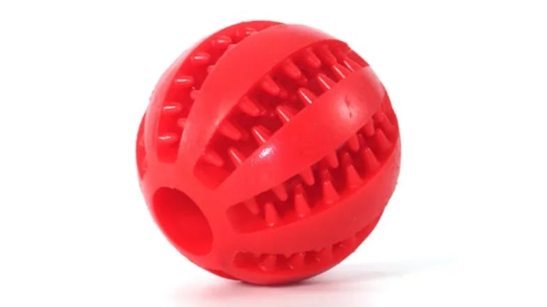 A textured red rubber ball with raised ridges and a hole A textured red rubber ball with raised ridges and a hole