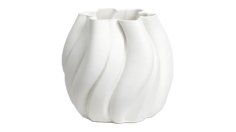 A minimalist white ceramic vase with a sculptural design A minimalist white ceramic vase with a sculptural design