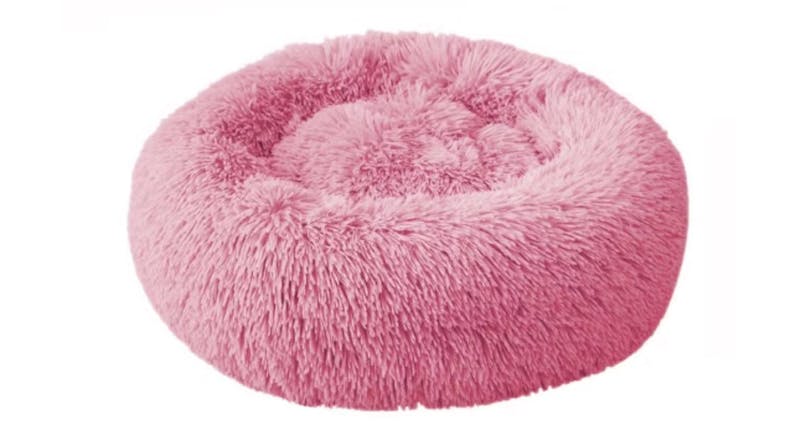A round, fluffy, pink pet bed designed for small animals like cats or dogs. A round, fluffy, pink pet bed designed for small animals like cats or dogs.