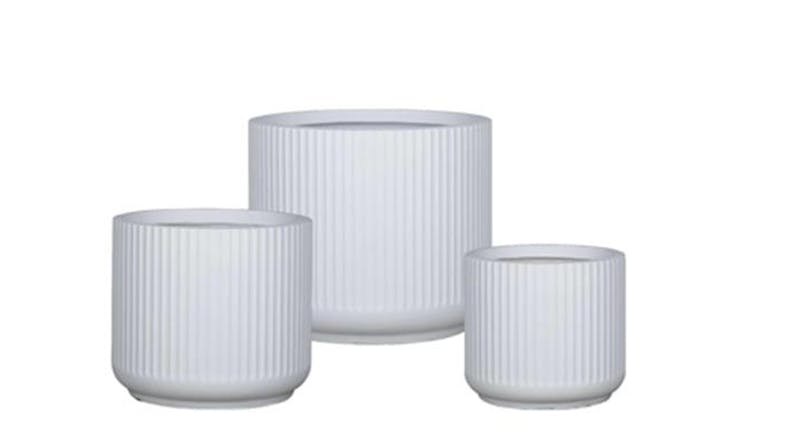 Three cylindrical planters with vertical ribbed texture, arranged by height from front to back in a staggered layout. Three cylindrical planters with vertical ribbed texture, arranged by height from front to back in a staggered layout.