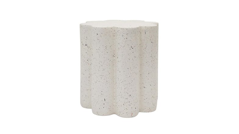 The flower-shaped side table features scalloped edges and a white flecked terrazzo-style finish. The flower-shaped side table features scalloped edges and a white flecked terrazzo-style finish.